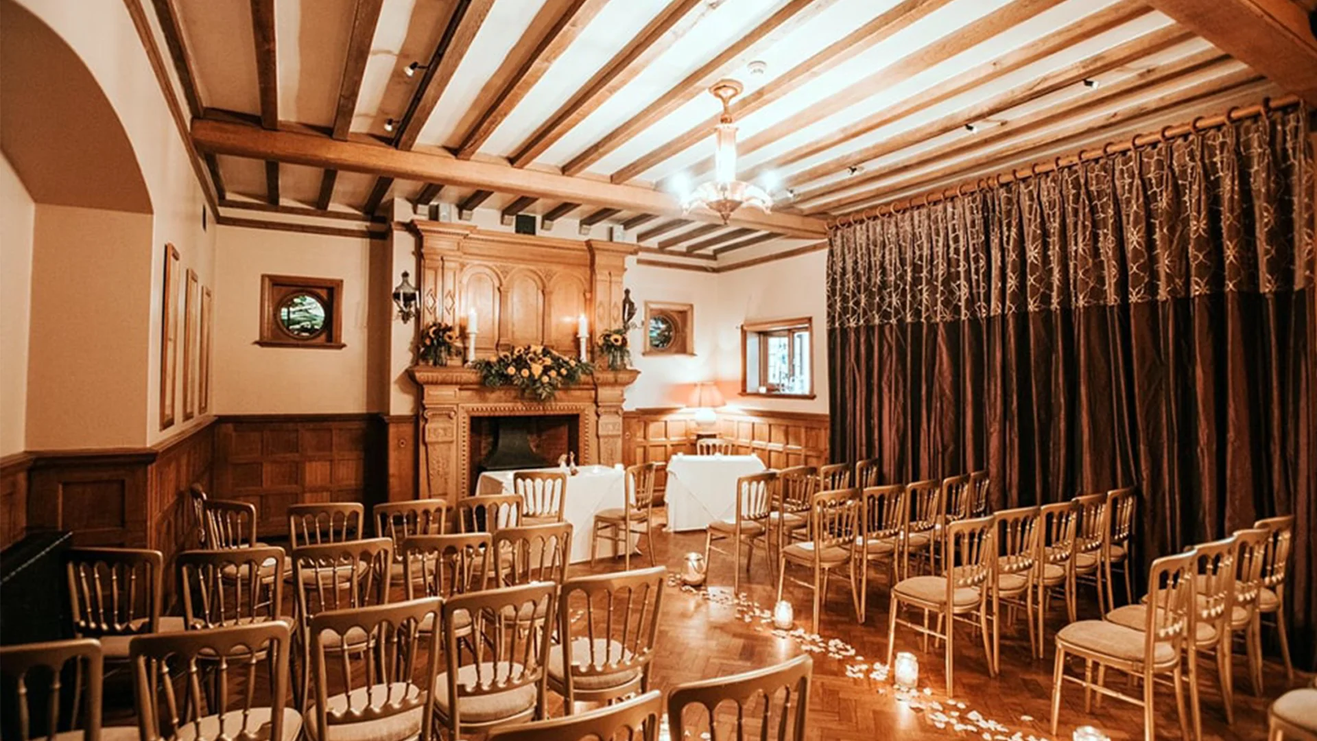 Blog 14 Elegant wedding reception setup in Prested Hall’s Oak Room with floral centerpieces and candles.