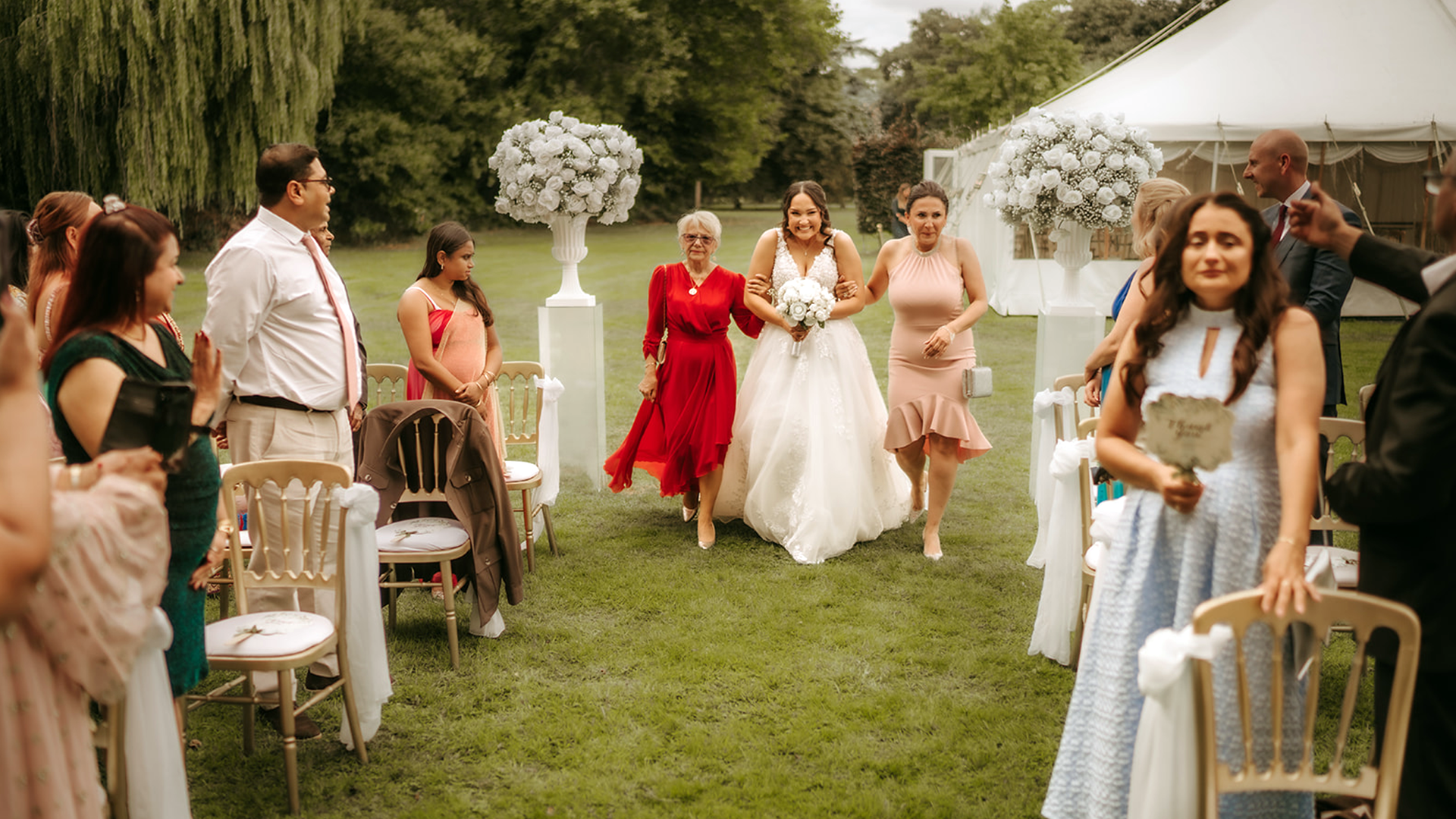 Blog 2 Bride walking down nature’s aisle in Prested Hall hidden garden outdoor ceremony